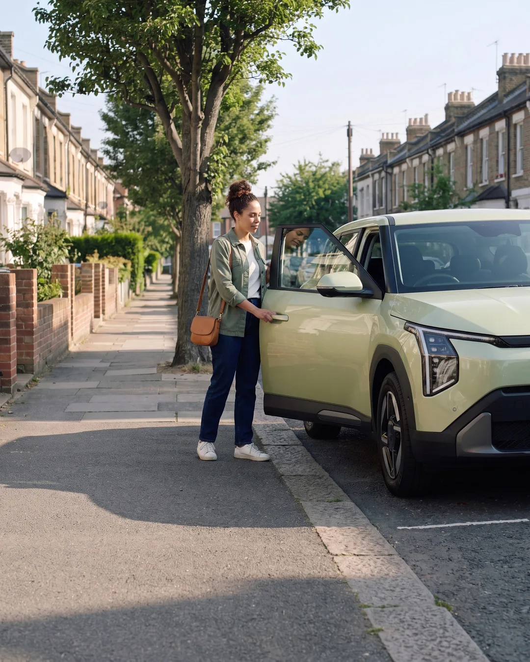 Maya getting into her car on her street.