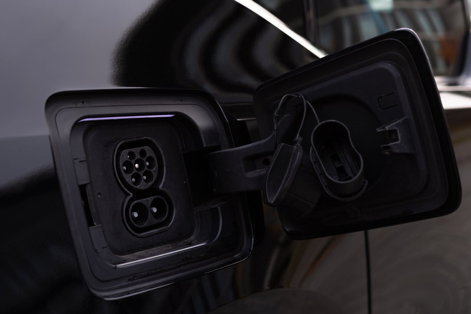 Close-up of an open charge port on an electric vehicle