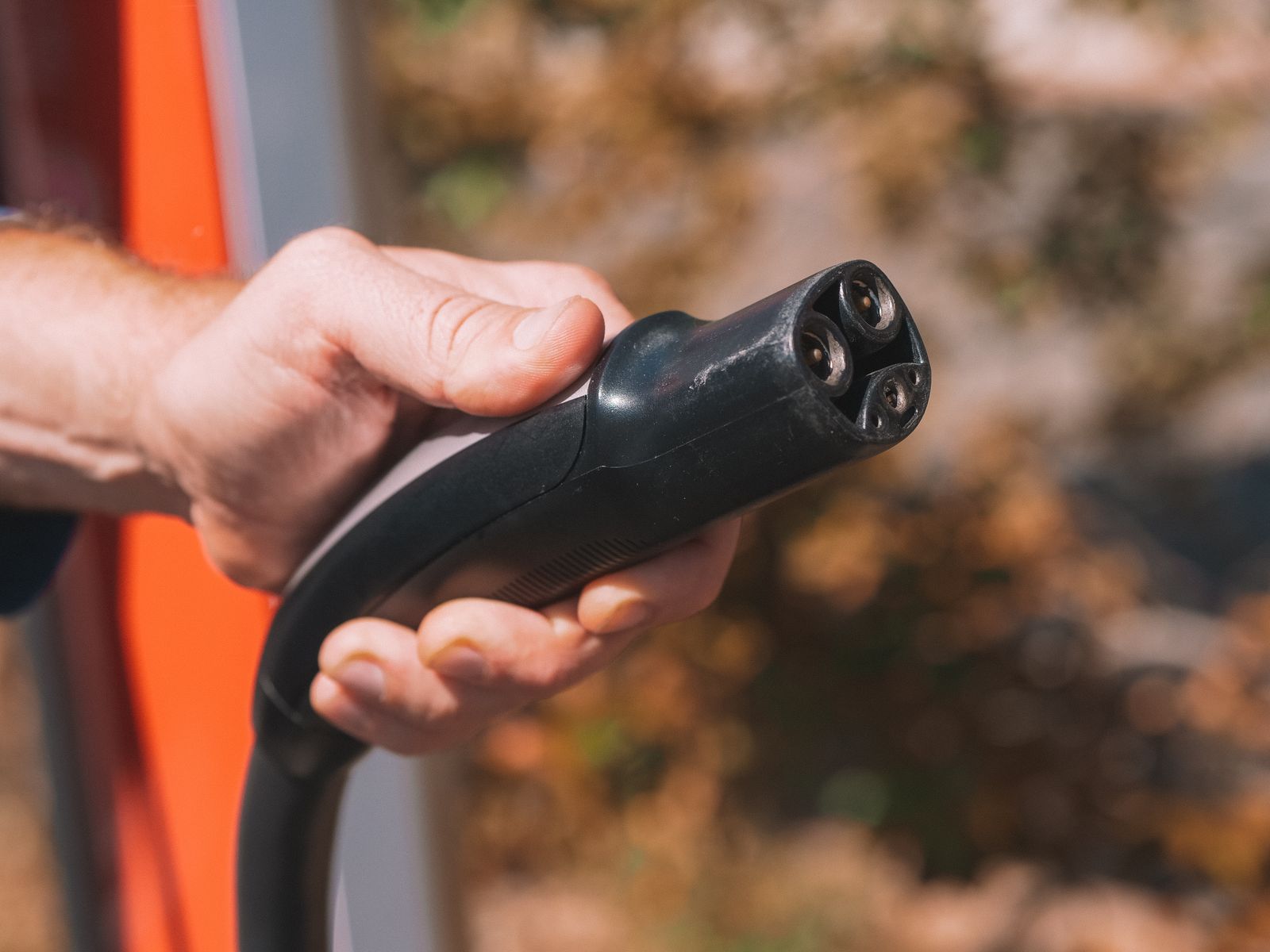Hand holding an EV charging connector