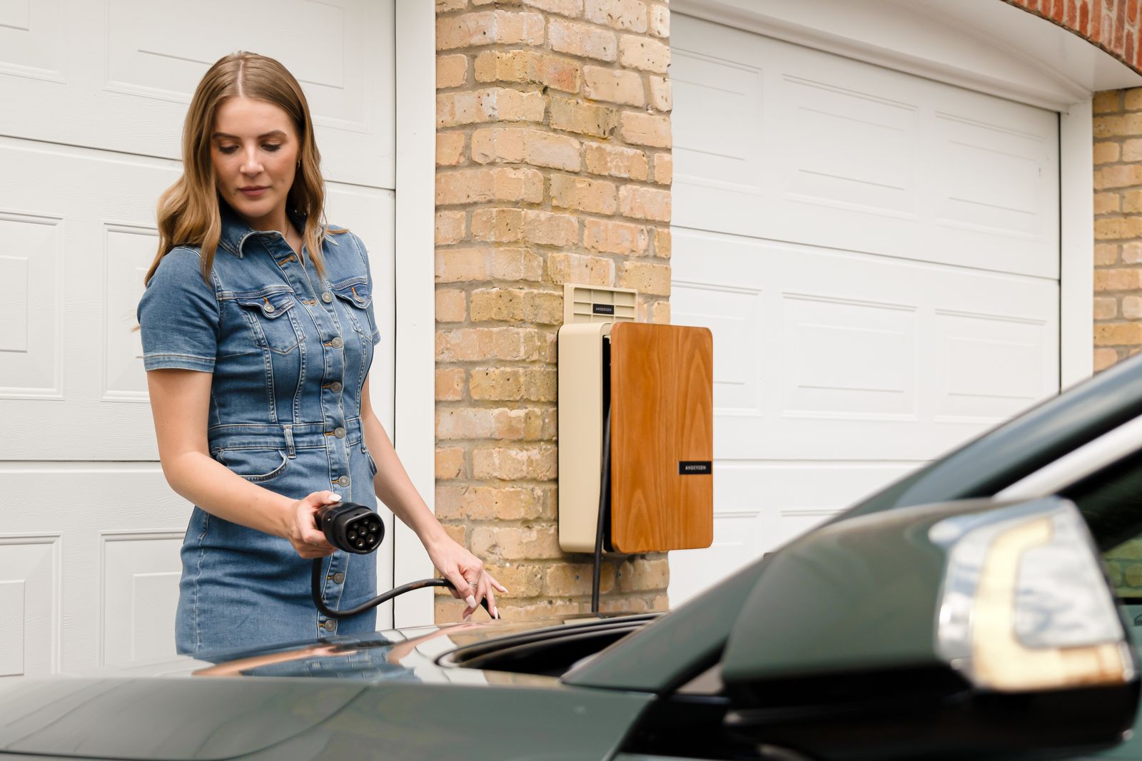 Someone charging their EV at a home wall charger